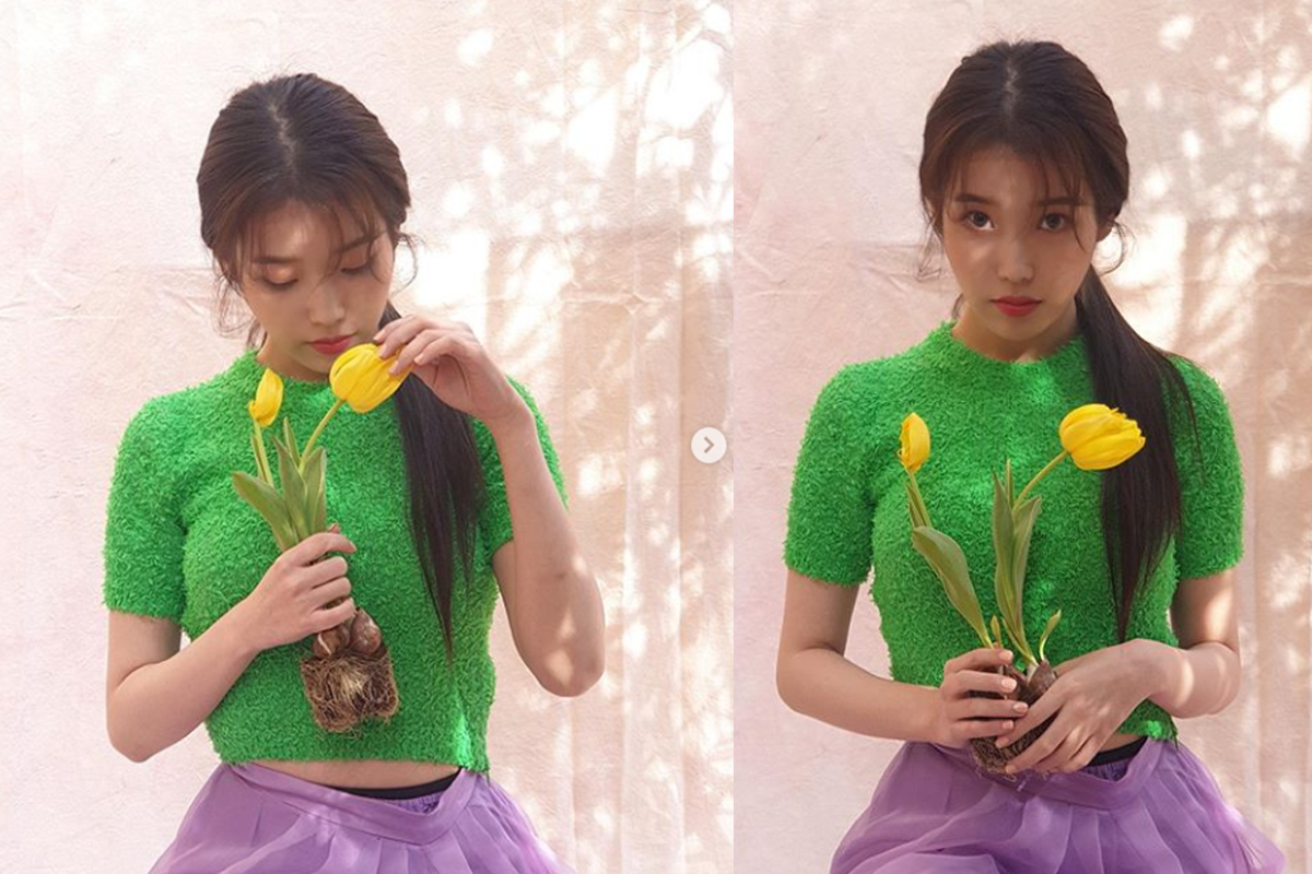 IU confused with flowers behind the scenes of her interesting photoshoot