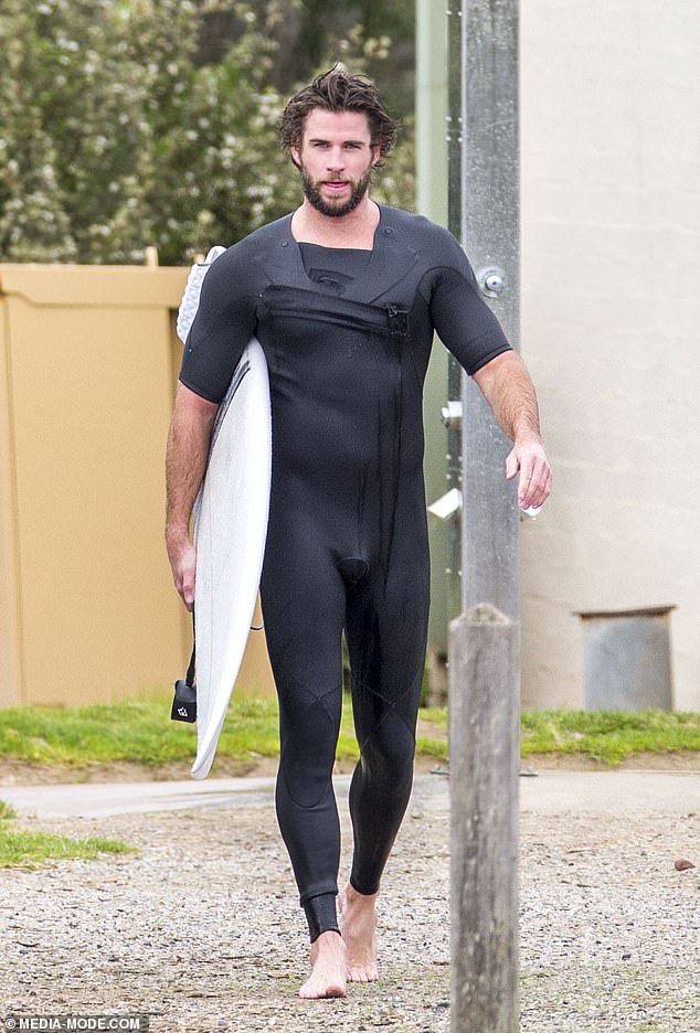liam-hemsworth-shows-off-a-snug-wetsuit-as-he-emerges-from-the-surf-on-phillip-island-1
