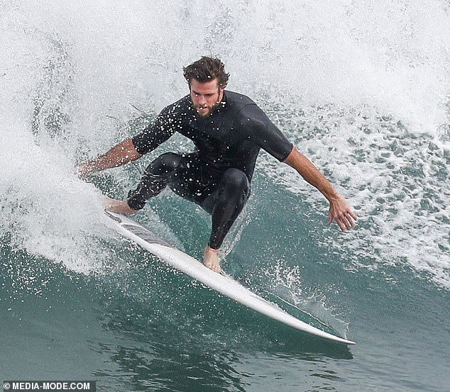 liam-hemsworth-shows-off-a-snug-wetsuit-as-he-emerges-from-the-surf-on-phillip-island-10