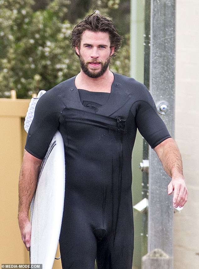 liam-hemsworth-shows-off-a-snug-wetsuit-as-he-emerges-from-the-surf-on-phillip-island-2