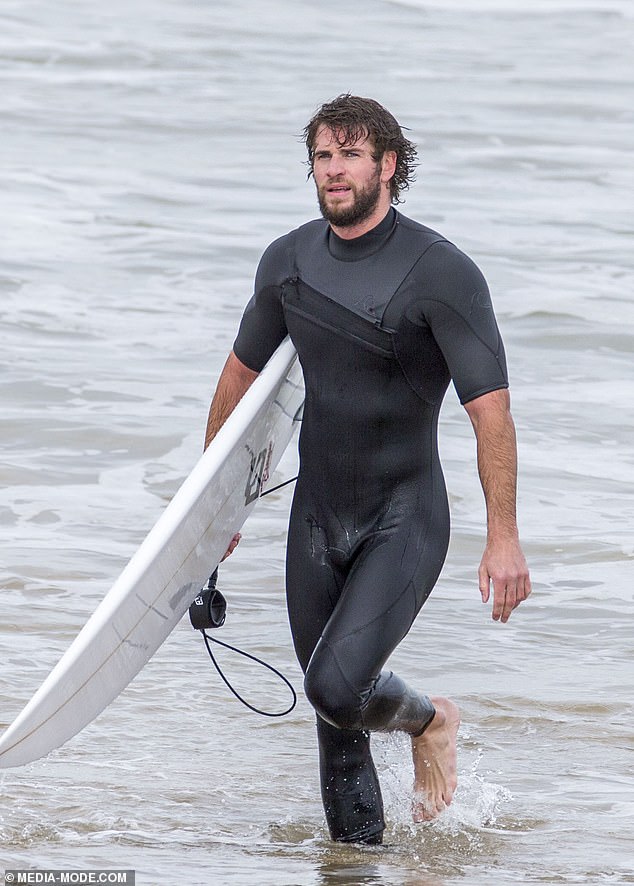 liam-hemsworth-shows-off-a-snug-wetsuit-as-he-emerges-from-the-surf-on-phillip-island-3
