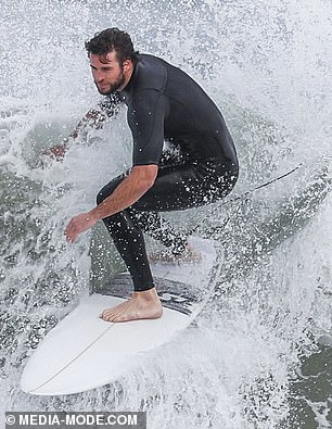 liam-hemsworth-shows-off-a-snug-wetsuit-as-he-emerges-from-the-surf-on-phillip-island-6