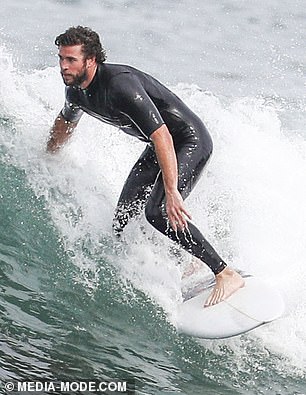 liam-hemsworth-shows-off-a-snug-wetsuit-as-he-emerges-from-the-surf-on-phillip-island-7