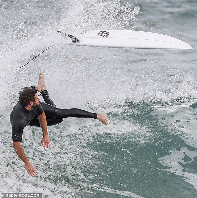 liam-hemsworth-shows-off-a-snug-wetsuit-as-he-emerges-from-the-surf-on-phillip-island-8