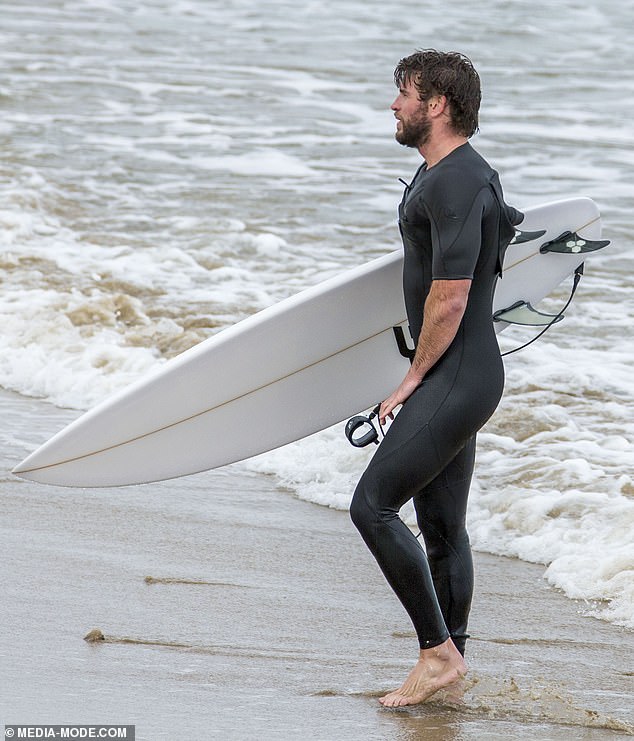 liam-hemsworth-shows-off-a-snug-wetsuit-as-he-emerges-from-the-surf-on-phillip-island-9