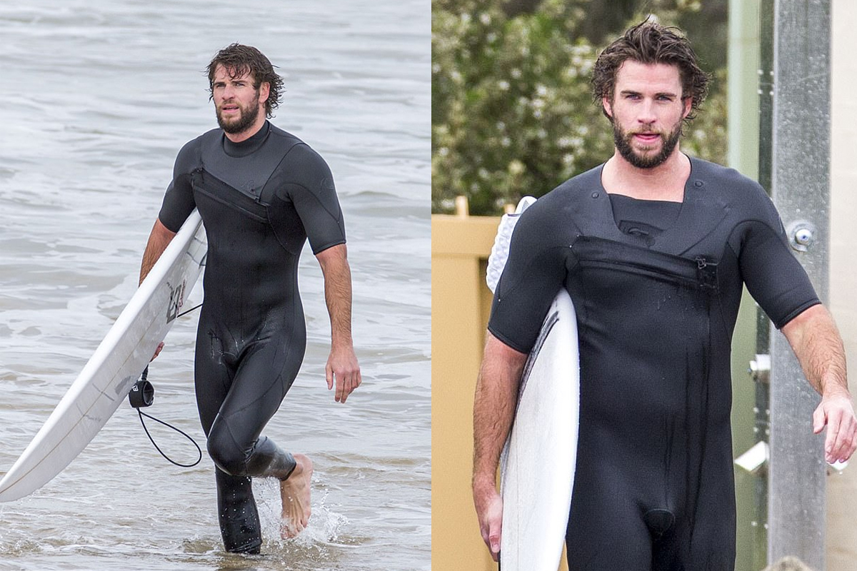 Liam Hemsworth shows off a  snug wetsuit as he emerges from the surf on Phillip Island