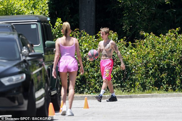 hailey-bieber-rocks-a-pink-crop-top-with-tiny-shorts-as-she-joins-her-shirtless-husband-justin-bieber-3