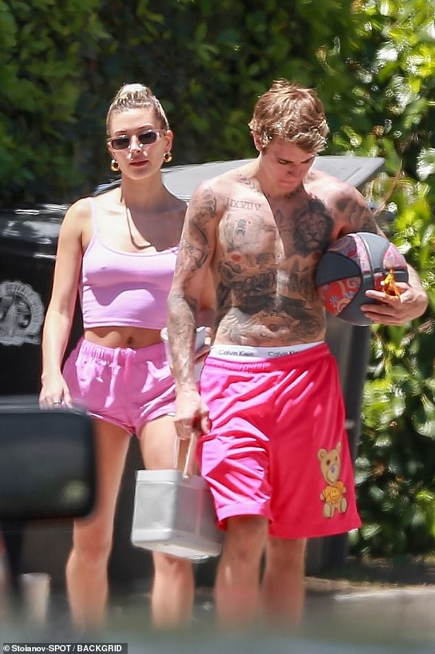 hailey-bieber-rocks-a-pink-crop-top-with-tiny-shorts-as-she-joins-her-shirtless-husband-justin-bieber1