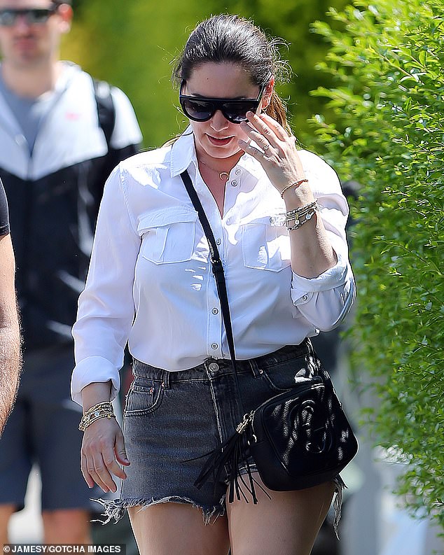 kelly-brook-puts-on-a-leggy-display-in-distressed-shorts-and-a-white-shirt-2