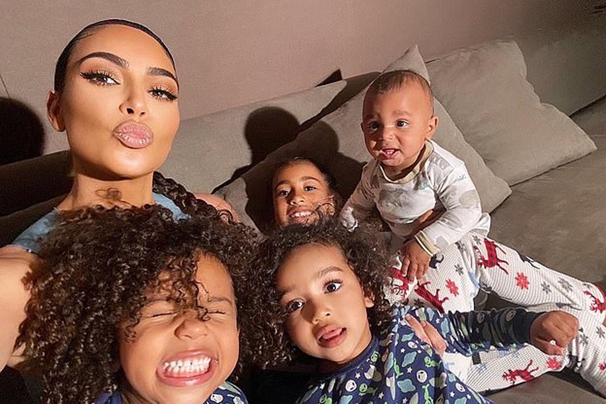 Kim Kardashian is all smiles as she gathers her four kids for selfies