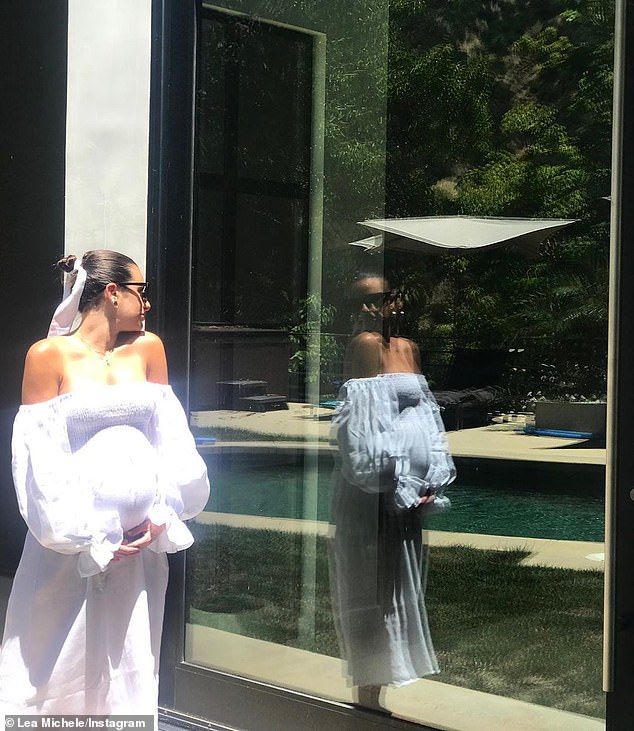 pregnant-lea-michele-cradles-her-baby-bump-wearing-a-white-flowing-dress-1