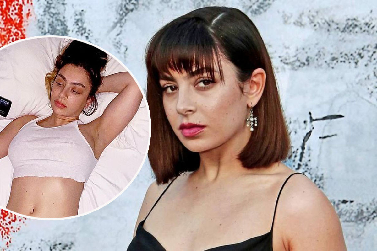 Charli XCX goes braless in a cropped white vest and matching underwear
