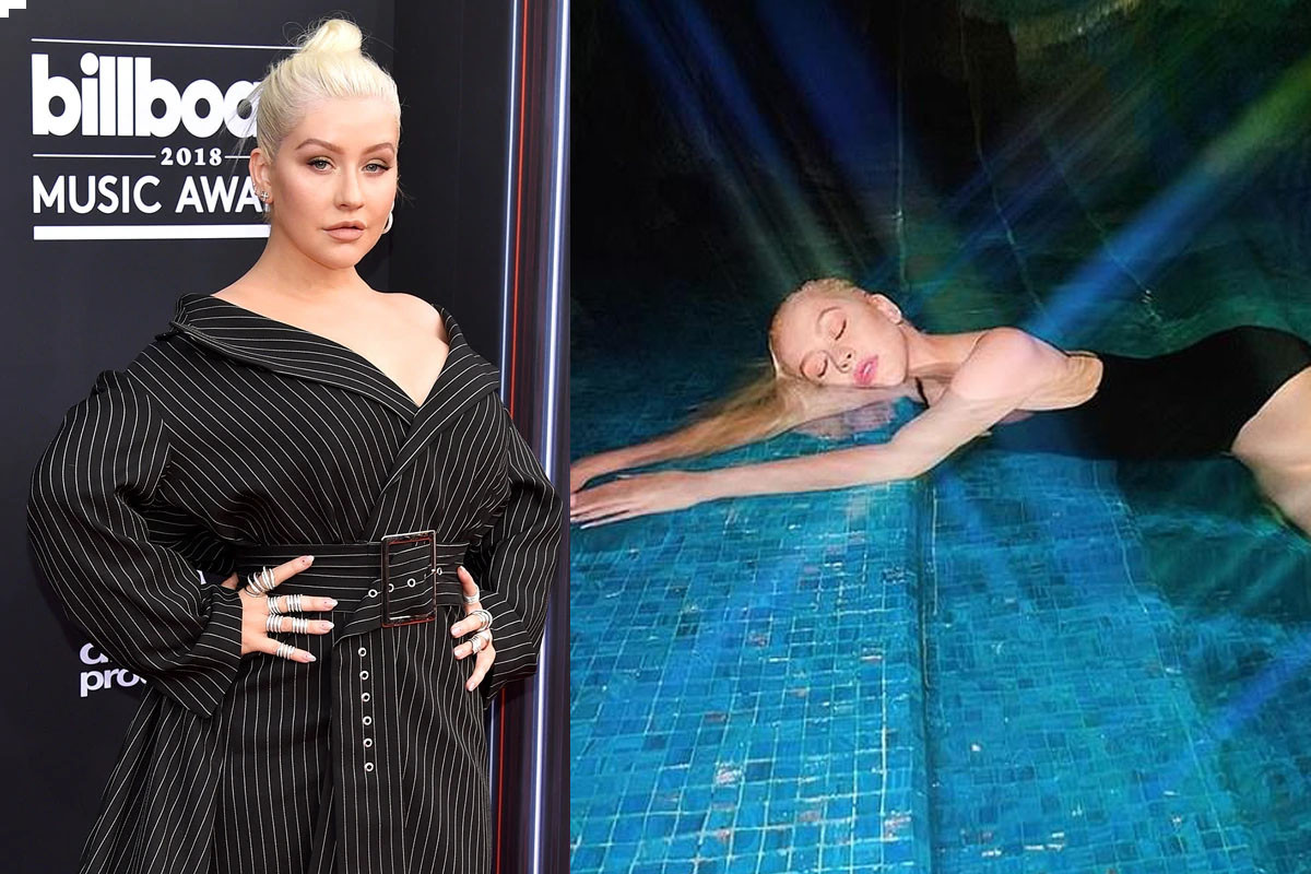 Christina Aguilera goes for a "recharging moonlight swim'' wearing a plunging black bathing suit