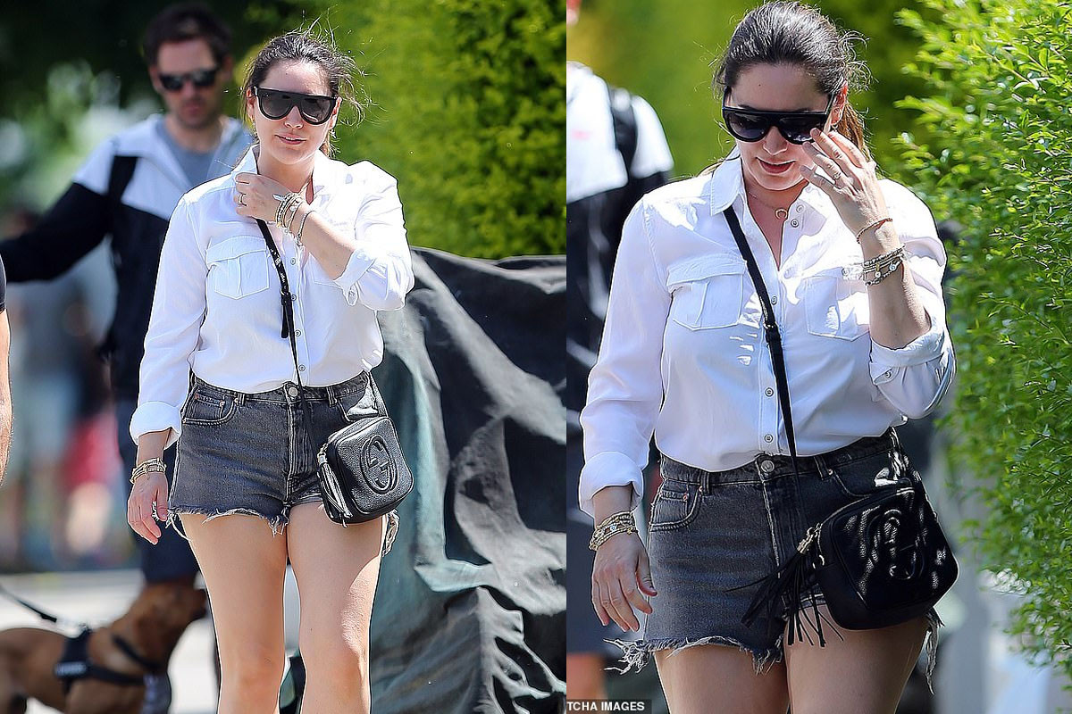 Kelly Brook puts on a leggy display in distressed shorts and a white shirt