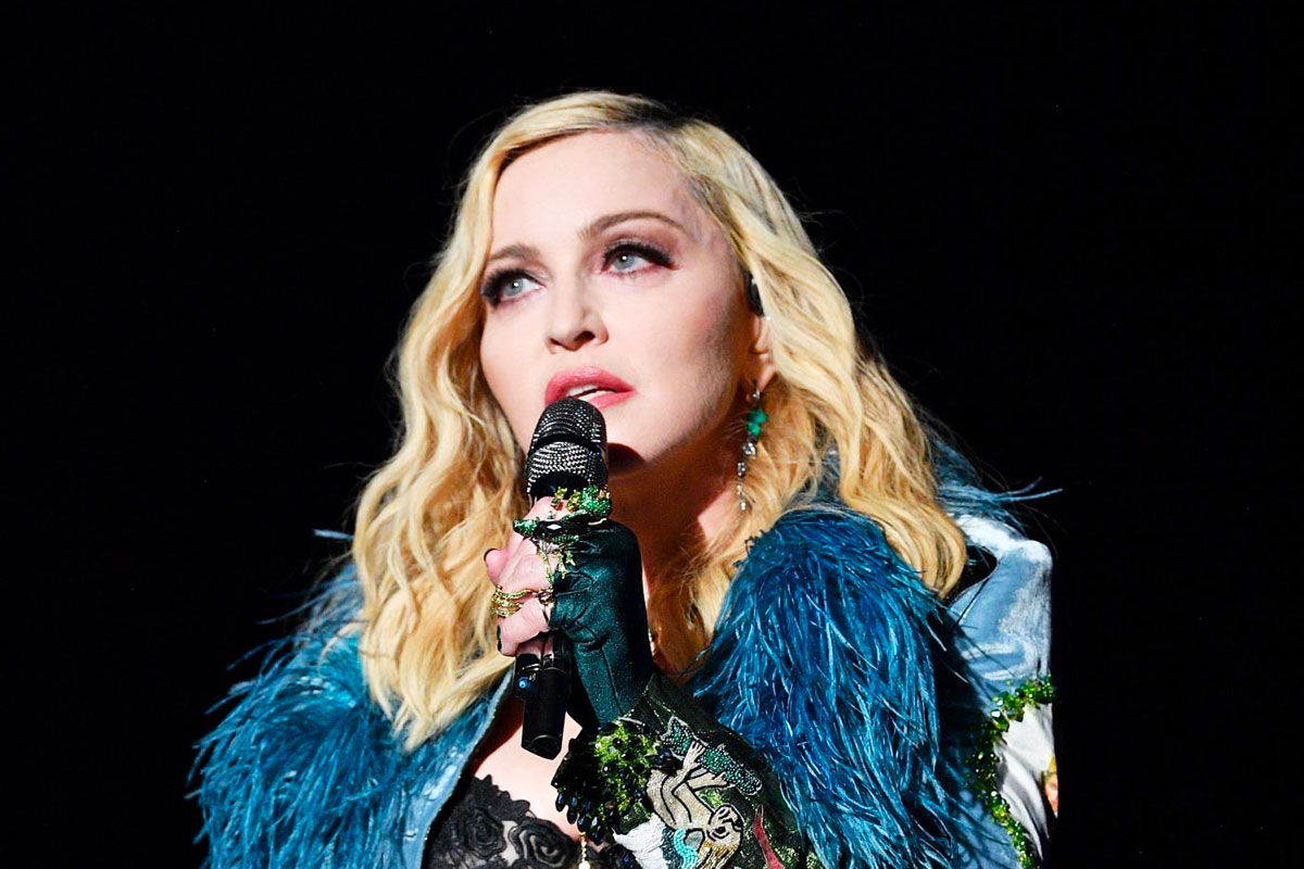 Madonna poses in topless with crutch after getting injured