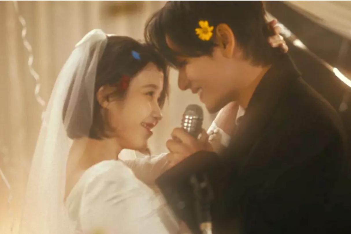 Watch: IU And BTS’s V Tell A Heartbreaking Love Story In Cinematic MV For “Love Wins All”
