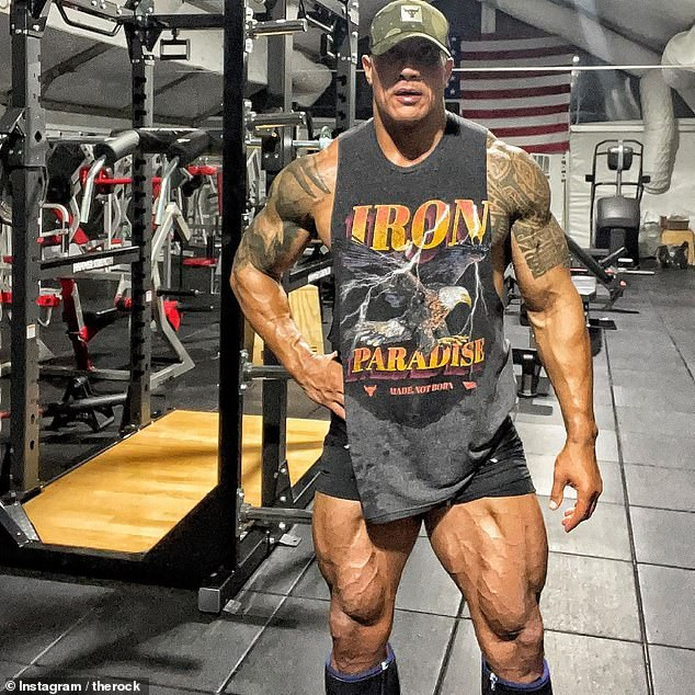 Muscle bound! A ripped Dwayne 'The Rock' Johnson, 49, showed off the results of his training during a late night gym session to prepare for scenes for upcoming film Black Adam - posting the snap on Instagram on Tuesday