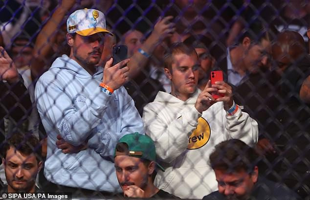 Spectators: The pair stood at one point at the event, produced by the Ultimate Fighting Championship, filming with their smart phones